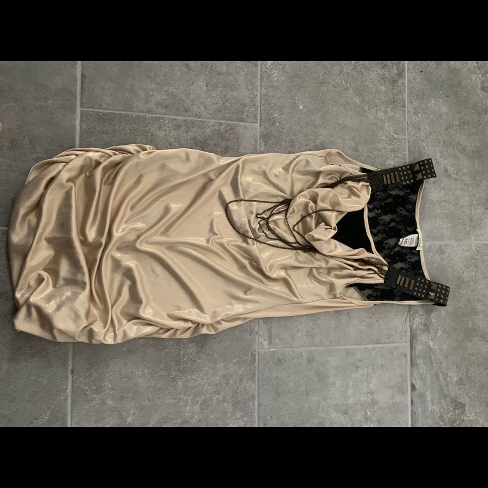 Gold colored dress with black lace and straps.